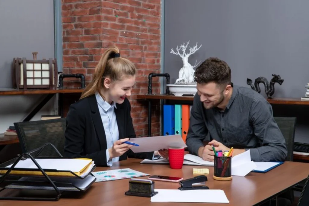 front view young positive satisfied clerical workers discussing one issue document office